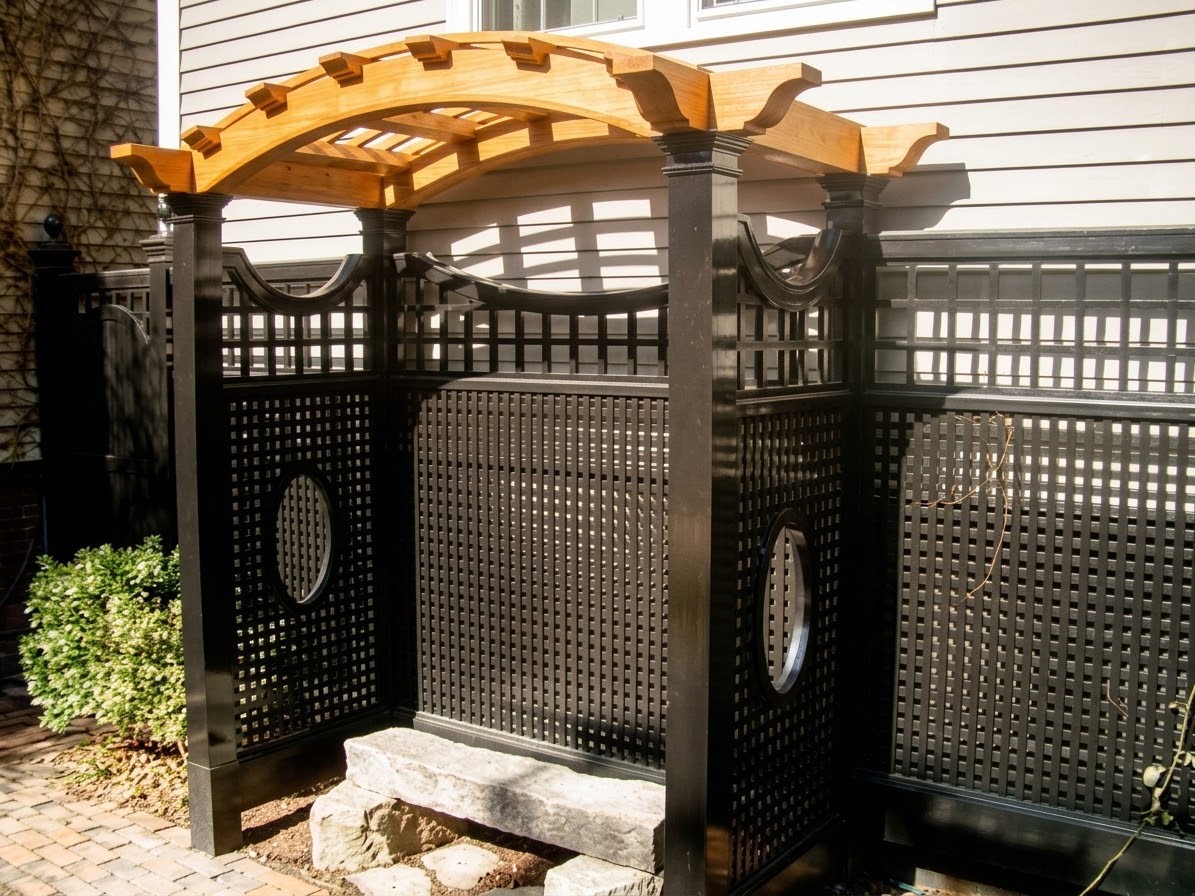 Curved timber arbor above lattice screens with circular openings